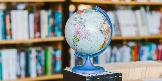 Kleiner Globus vor einem Bücherregal