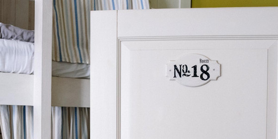 Weiße Tür mit der Aufschrift „Room No. 18“